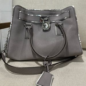 Michael Kors gray purse with silver accents